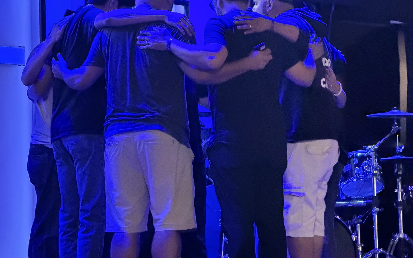 Men praying for one another at the church planting conference in Rosarito